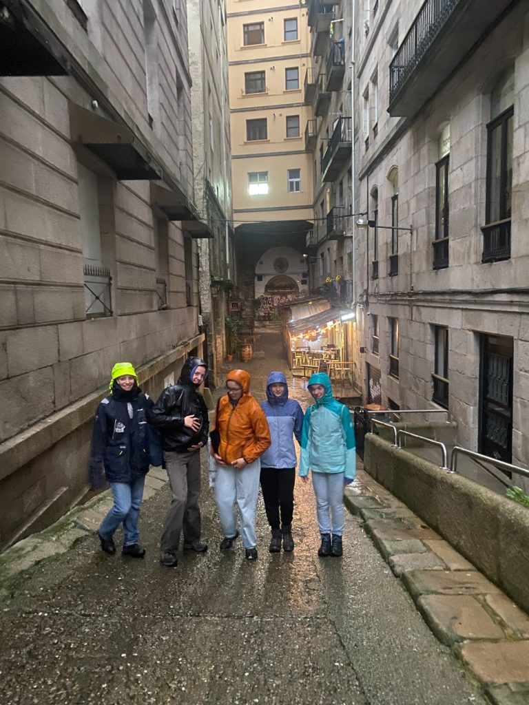 Schülerinnen laufen im Regen durch die Stadt Vigo.
