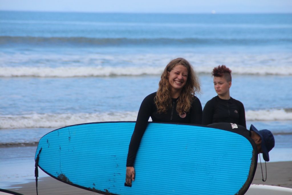 Girls surfing at Ocean College